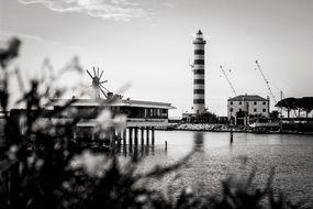 distant view of the lighthouse in the spa town of jesolo, black and white