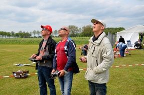 men with radio-controlled devices