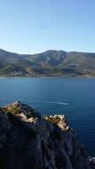 boat sailing along the seashore view from the cliff