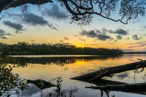 romantic bright sunset is reflected in the river