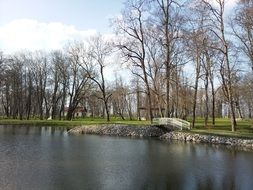 distant view of a foot bridge over a lake in a park