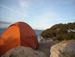 the tent stands near the cliff