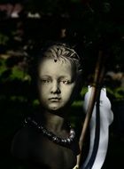 sculpture of a child in the dark