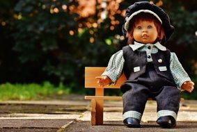 vintage doll on a wooden bench