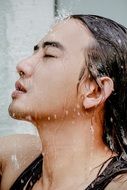man's face in splashes of water