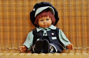 doll sits on a chair