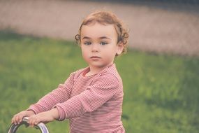 child in a striped sweater with curly hair