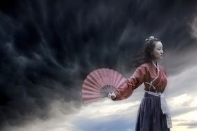 girl in a kimono with a fan in her hand