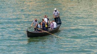 people in gondola on the river