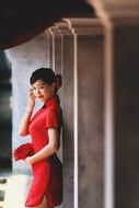 photo of the girl in a red dress with a bouquet in Vietnam