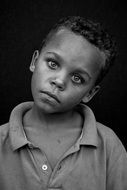 black-white portrait of a poor child