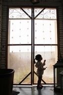 Silhouette of the girl near the window