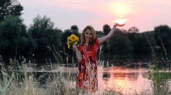 girl with sunflower bouquet at sunset
