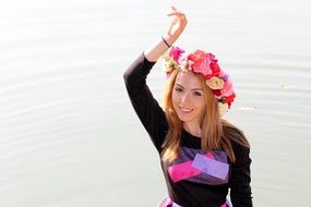 girl in a colorful wreath near the water on a clear day