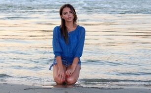 beautiful lady sitting on the beach