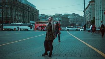 photo of a girl on a background of a red bus in Moscow