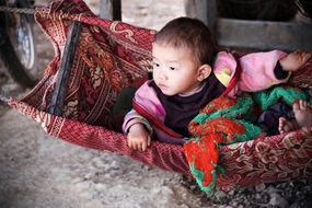 Asian baby boy in cradle