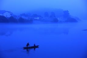 boat with people on the water at dusk