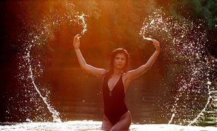 sensual brunette in spray of water