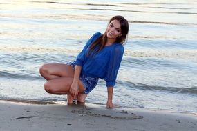 sensual girl near the water in the evening