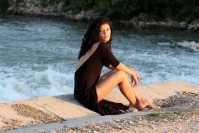 girl in black near the water in summer