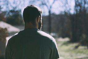 photo of a man with a beard from the back
