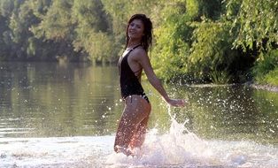 seductive brunette splashing in the water
