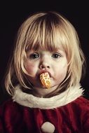 sad blonde child girl with Orange in mouth, portrait