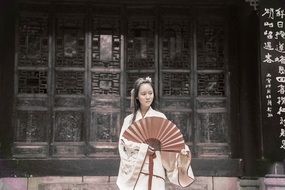 Asian woman in kimono with a fan