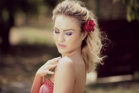 portrait of sensual blonde with a flower in her hair