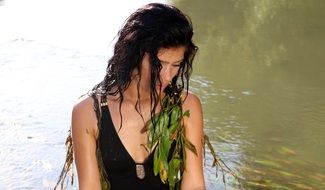 girl in a black bathing suit in the water close-up