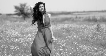 black and white picture of a brunette on the meadow