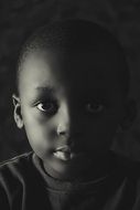 black and white photo of an african boy