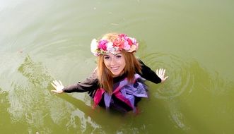 portrait of smiling Girl with flower Wreath in Water