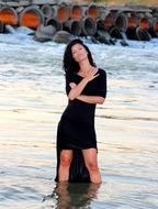 sensual brunette standing in the water