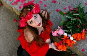 young sexy Girl in red Flower Wreath looking up