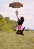 girl dressed as Minnie jumps with umbrella