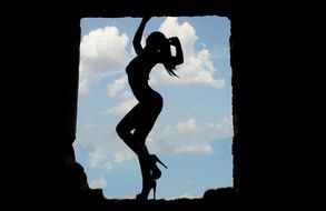 silhouette of a sexy girl in the window of the fortress