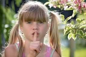 photo of a girl with a finger at her lips