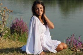 Photo of a girl in a white dress by the river