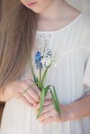 girl in a white dress with meadow flowers