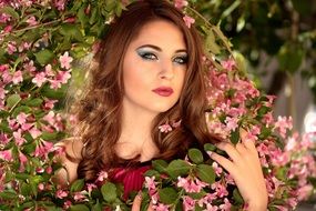 pretty woman posing in the spring bush