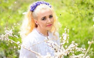 blonde girl near a flowering bush