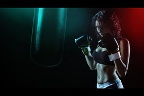 dark photo of a girl boxer in gloves