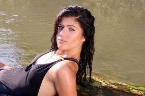 sensual girl in water in wild nature close up