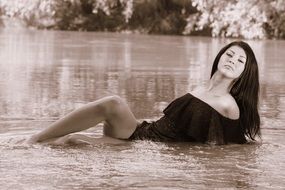 Sepia portrait of a girl in water