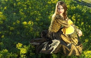 Girl in princess dress on a flower field