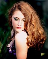 beautiful caucasian girl with long red hairs posing outdoor