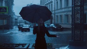 girl with a big umbrella on a city street