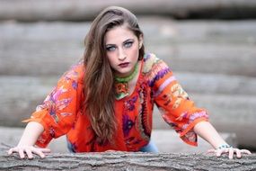 girl in a colorful dress near a tree